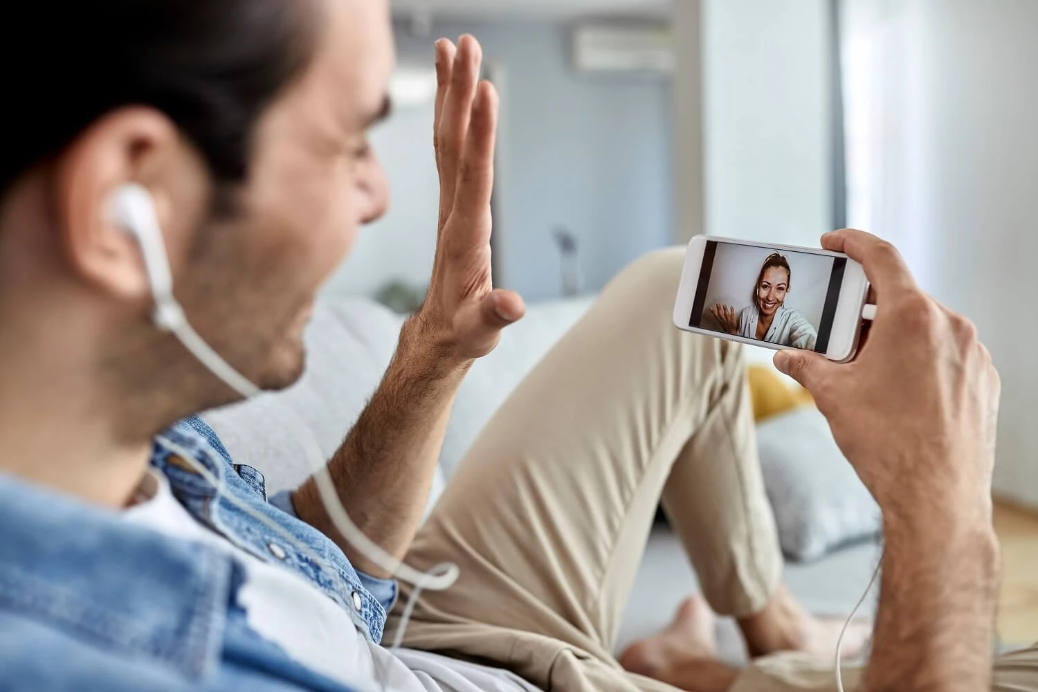 closeup-man-using-mobile-phone-waving-while-having-video-chat-with-his-girlfriend (1).jpg